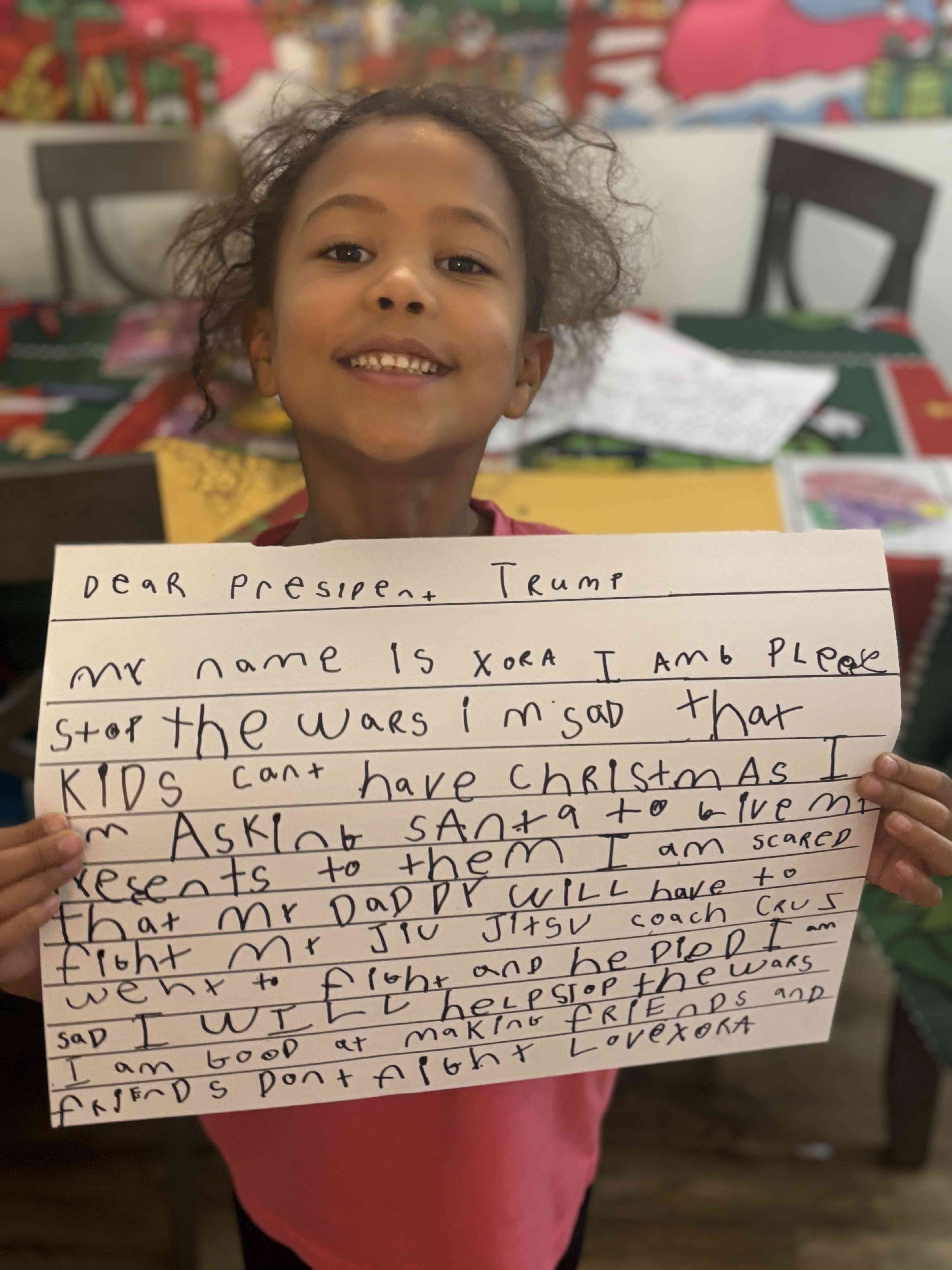 Xora holding her letter about stopping wars